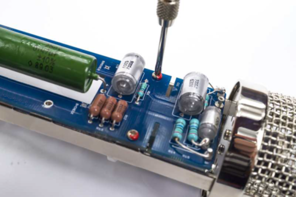D-12 PCB assembly being inserted into the microphone body from the top.